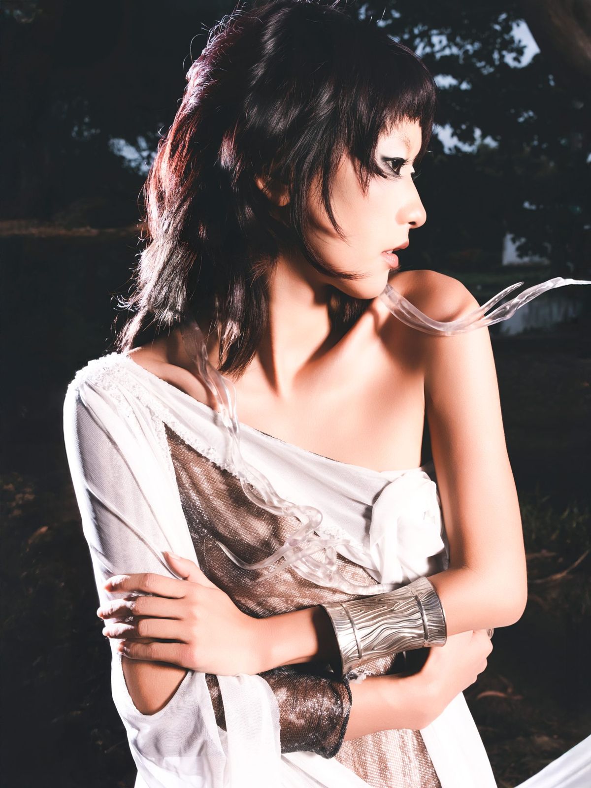 Close portrait with metallic cuffs and tousled hair